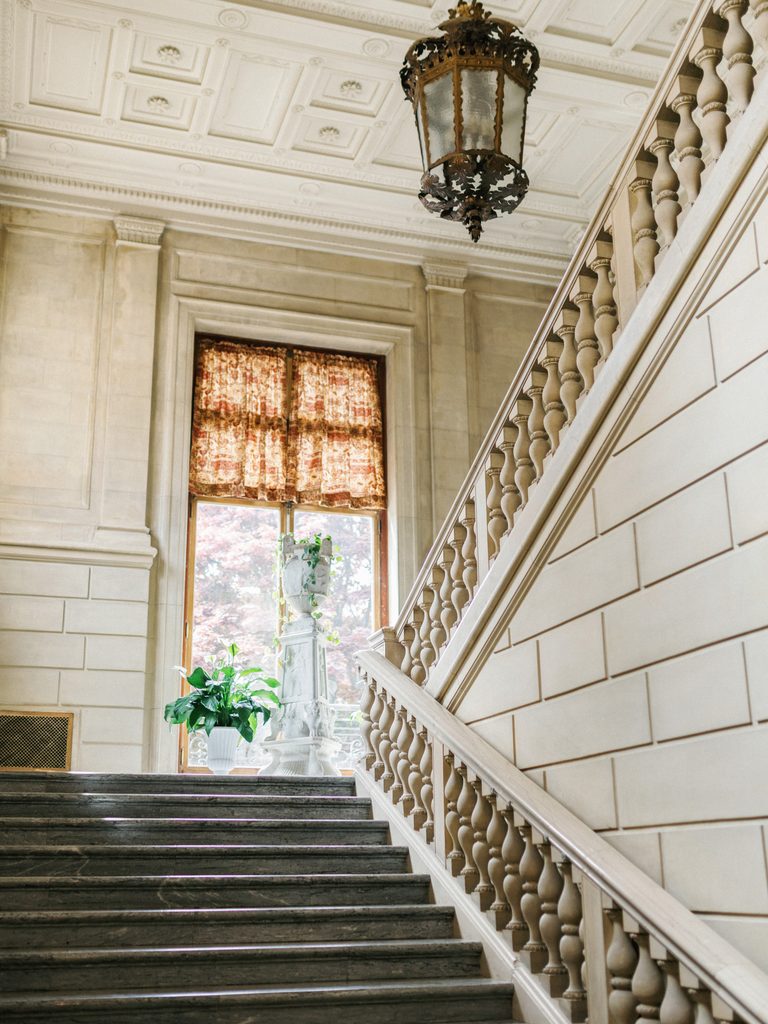 Grand Aldrich Mansion wedding staircase indoor scenery with a majestic stone stairway and a large bright window