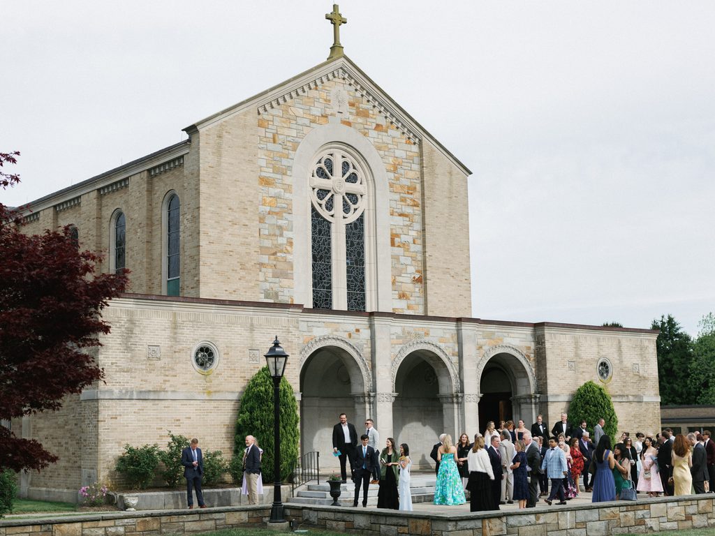 Grand Aldrich Mansion wedding chapel exterior featuring wedding guests gathering outside the historic stone cathedral entrance