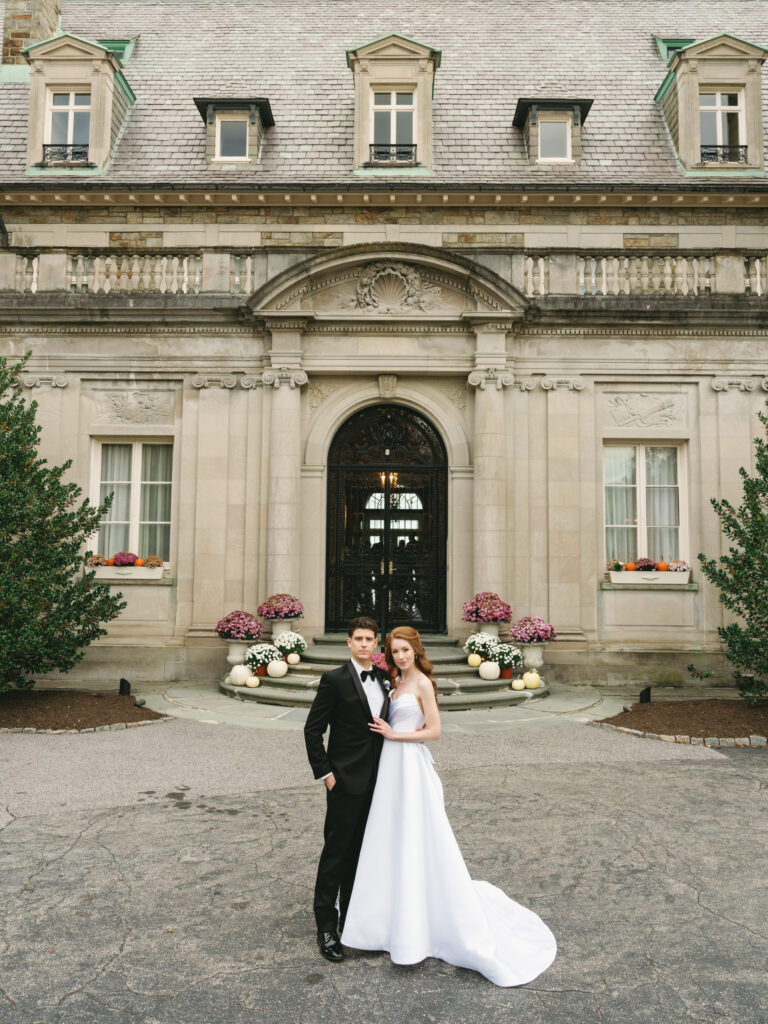 Stunning Aldrich Mansion wedding portrait of a bride and groom posing in front of the grand historic estate entrance