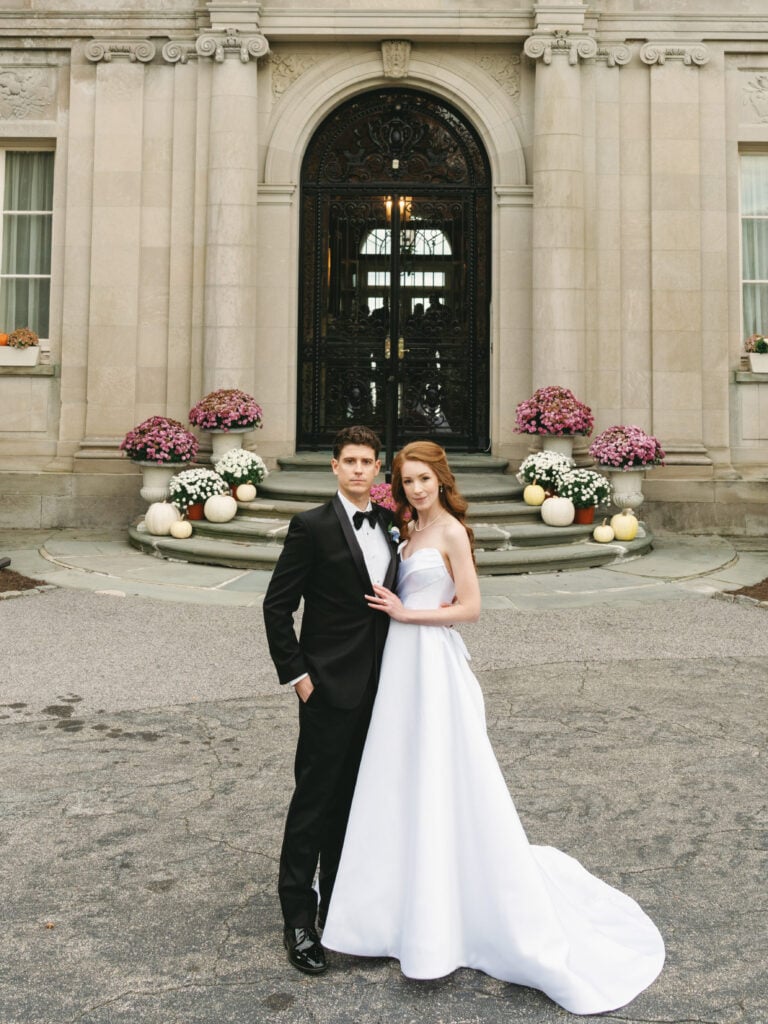 Stunning Aldrich Mansion wedding portrait of a bride and groom posing in front of the grand historic estate entrance