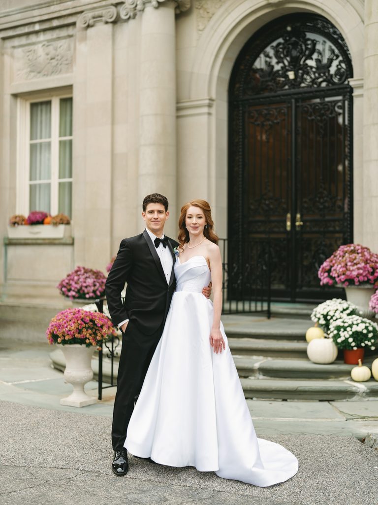 Timeless Aldrich Mansion wedding portrait of a elegant bride and groom posing together by the historic mansion front entrance