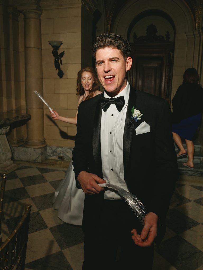 Luxury wedding send off inspiration featuring a happy couple dancing through light up fiber optic sticks during a reception wrap up
