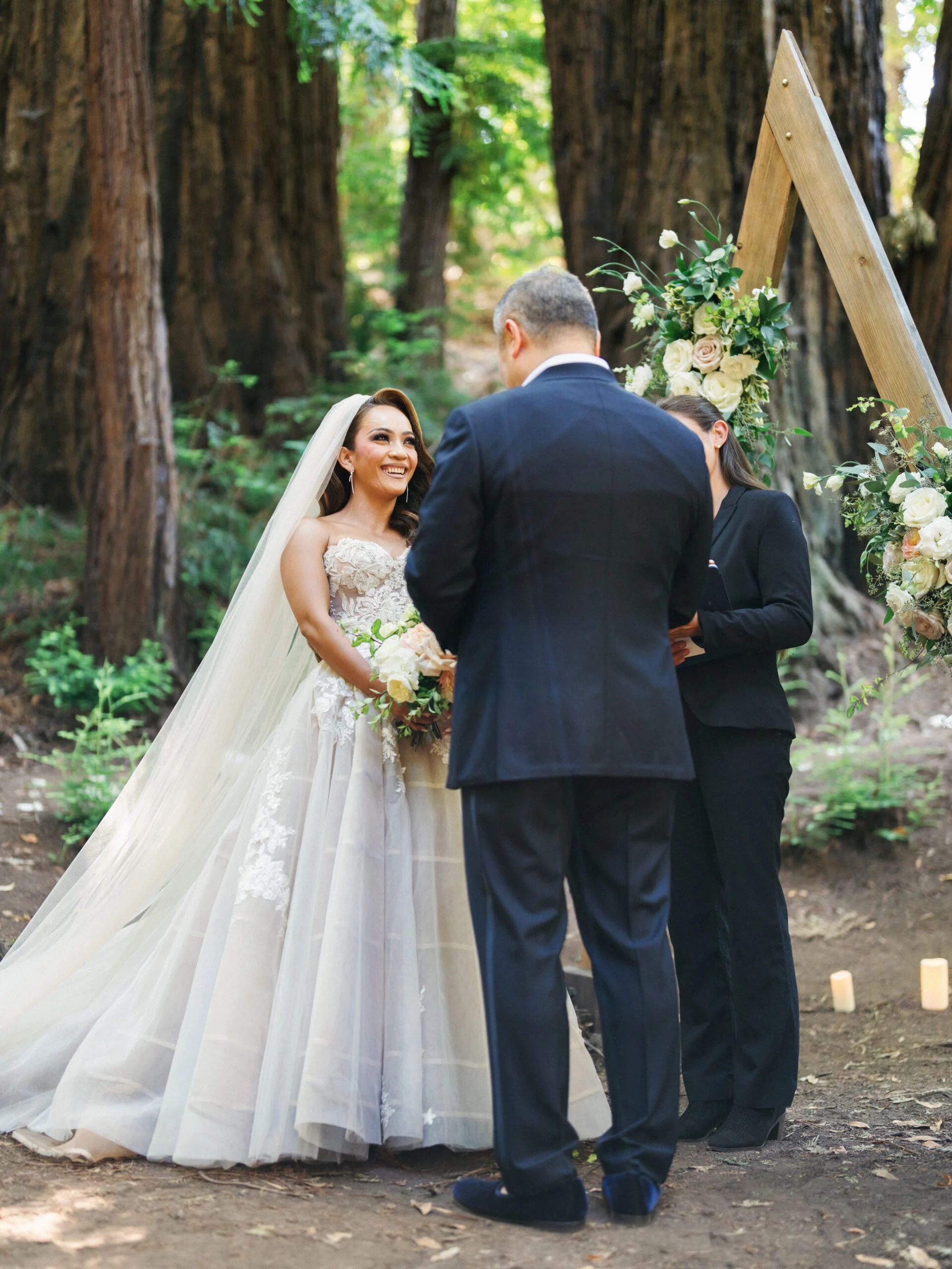 Couple exchanging vows in a redwood forest ceremony