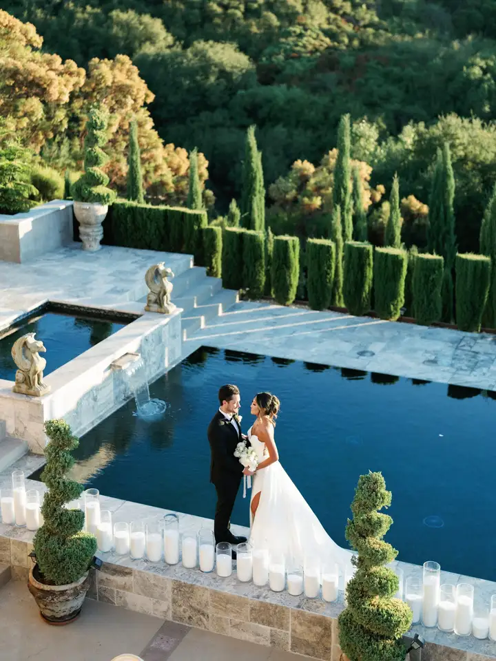 Bride and groom beside a reflecting pool